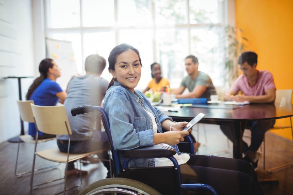 Mujer en silla de ruedas incluida en ambiente laboral